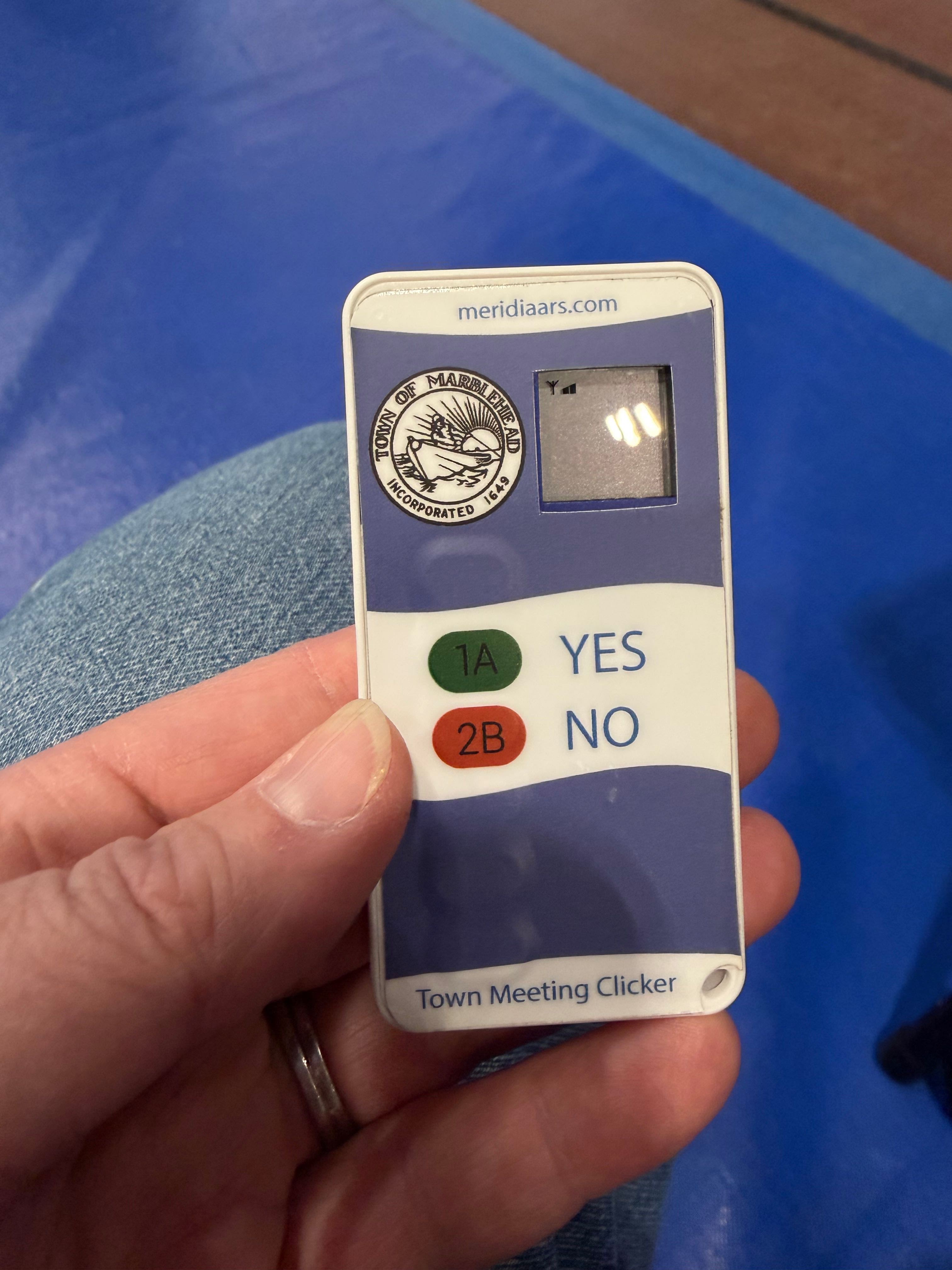 A Town of Marblehead Town Meeting electronic voting clicker, with a green 1A YES button and a red 2B NO button.