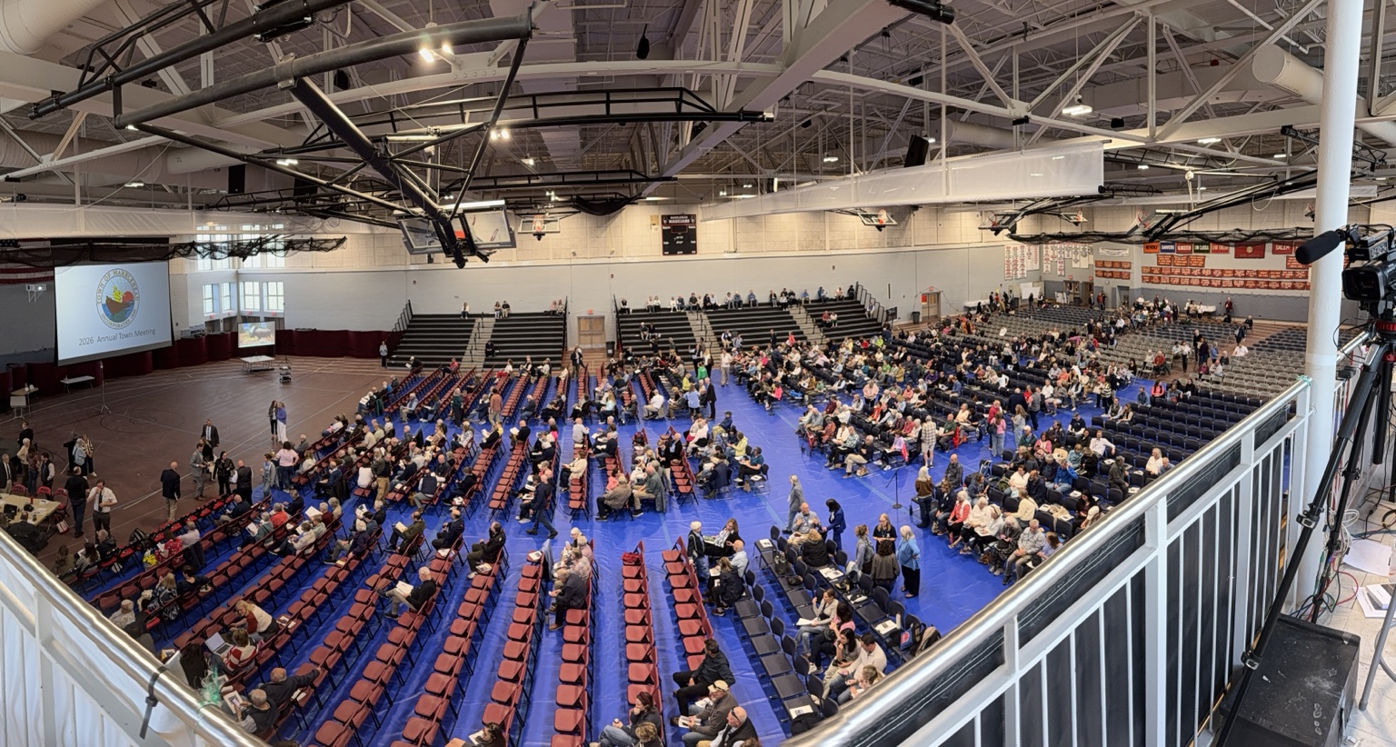 View from the press balcony of the Marblehead High School Field House as residents fill the floor before the 2026 Annual Town Meeting.