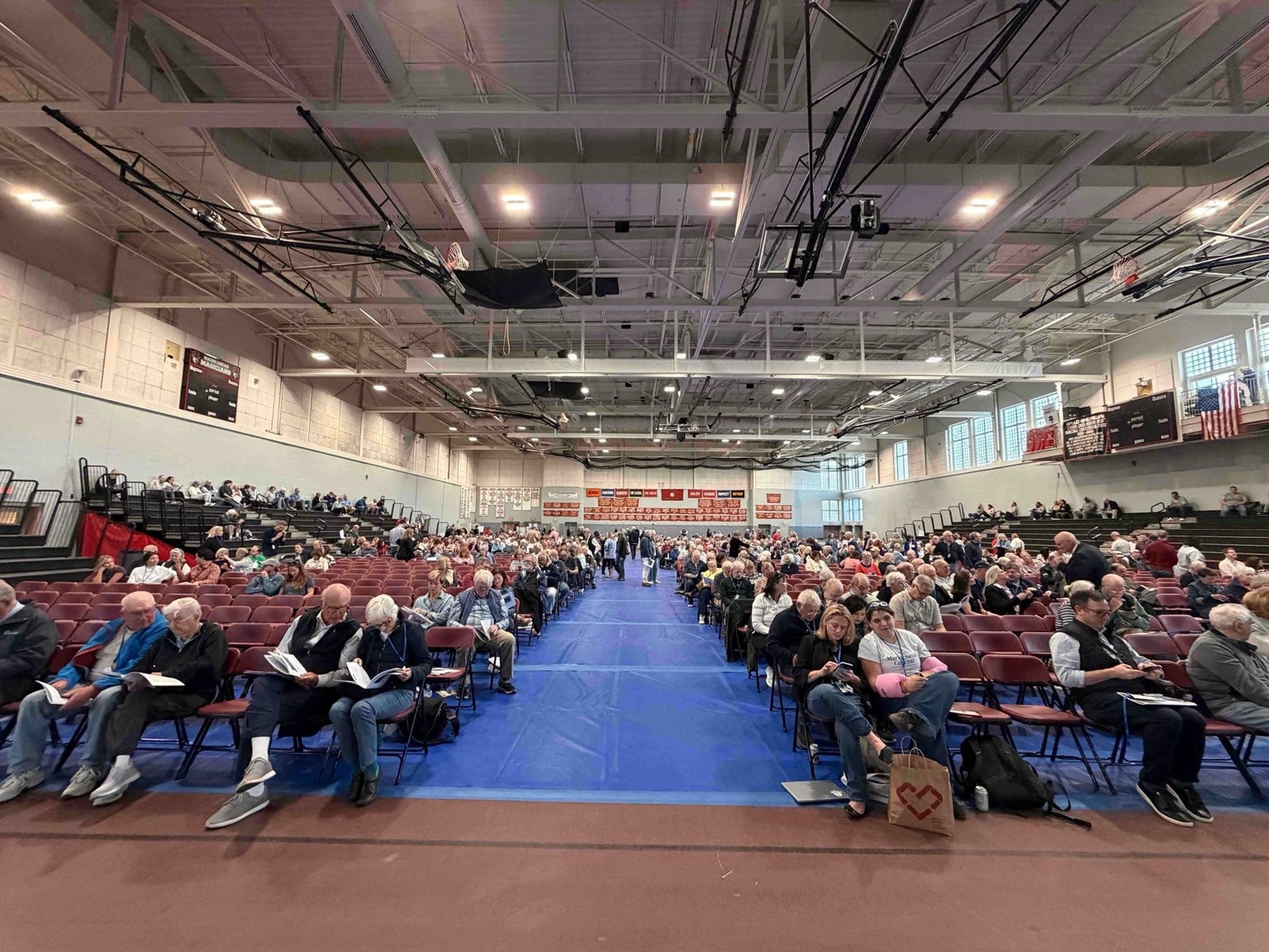 Voters fill the floor of the Marblehead High School Field House at the start of the 2026 Annual Town Meeting.