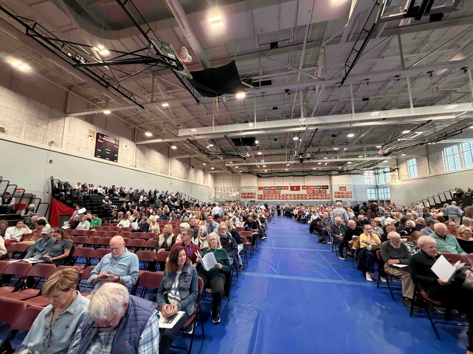 A center aisle splits the Field House floor as voters prepare for the start of Town Meeting.