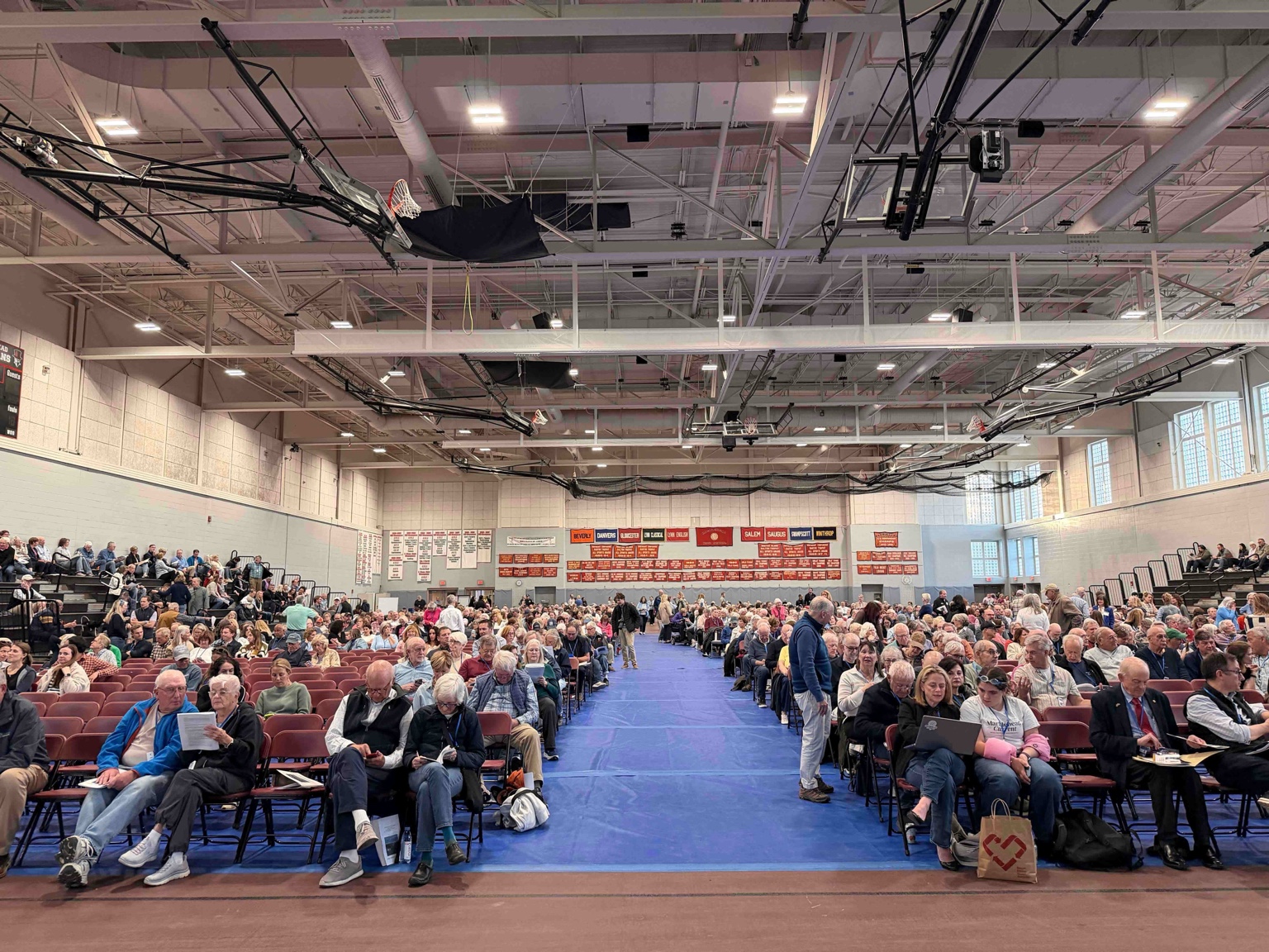 The Town of Marblehead seal projected on the main screen at the front of the Field House at the start of Town Meeting.