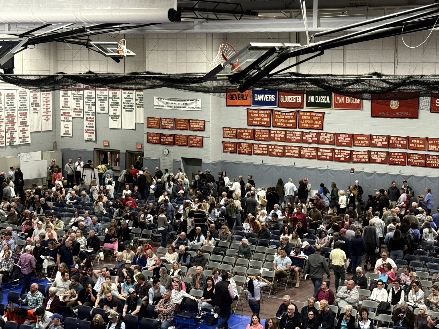 Voters file out of the Marblehead High School Field House moments after Article 29 cleared the floor.
