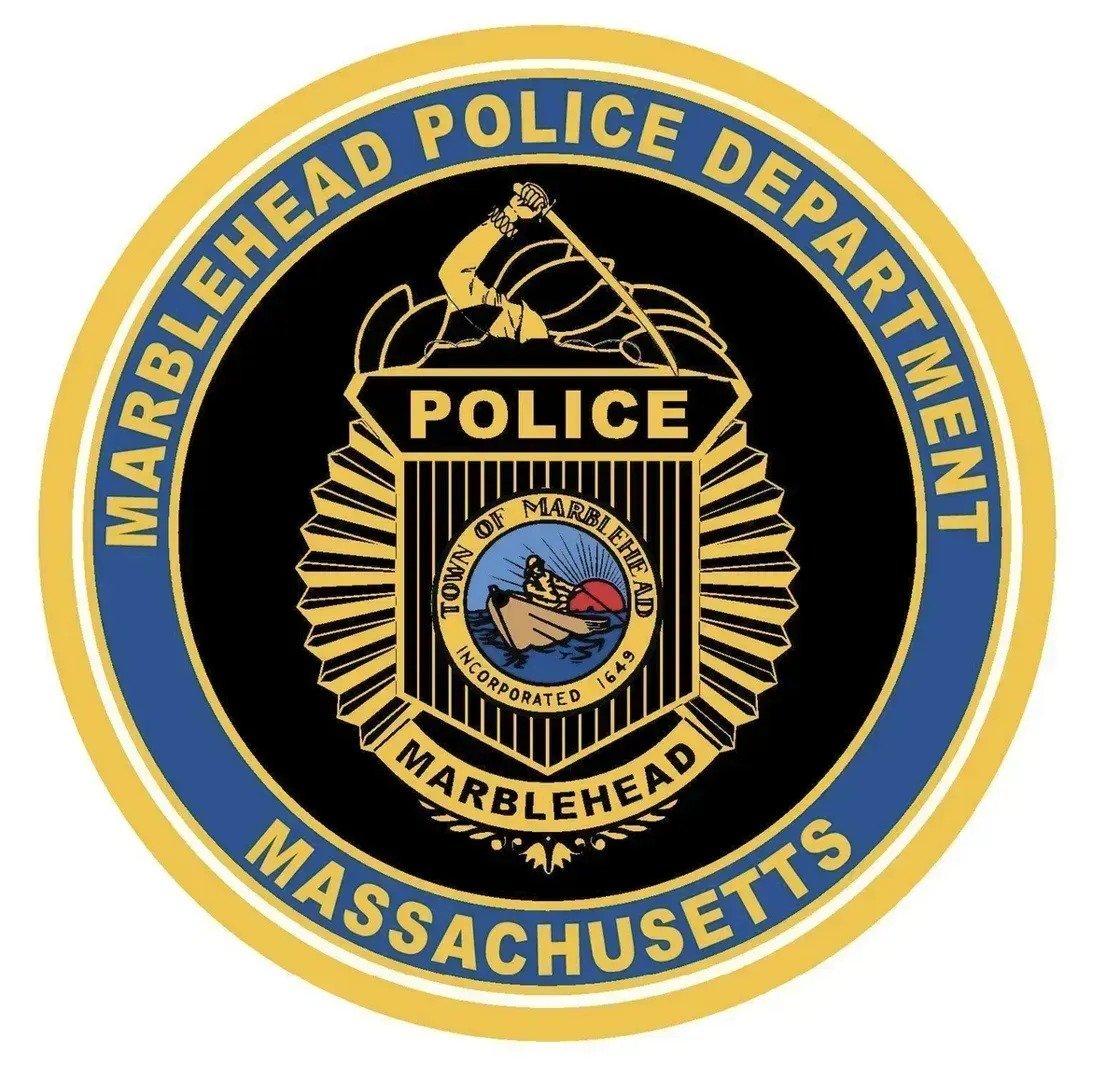 Marblehead Police Department seal, a gold badge on a round blue and black emblem